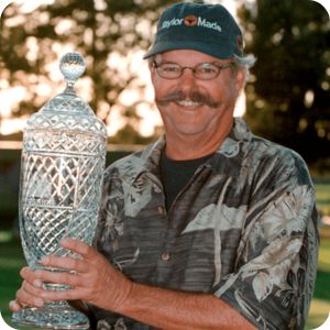 Gary McCord holding the Hoag Classic trophy